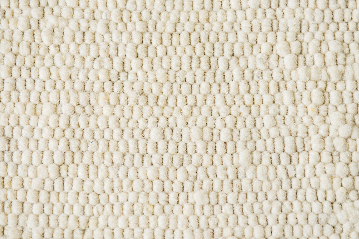 Close-up van Texelkleed Branding, gemaakt van witte Texelse schapenwol.