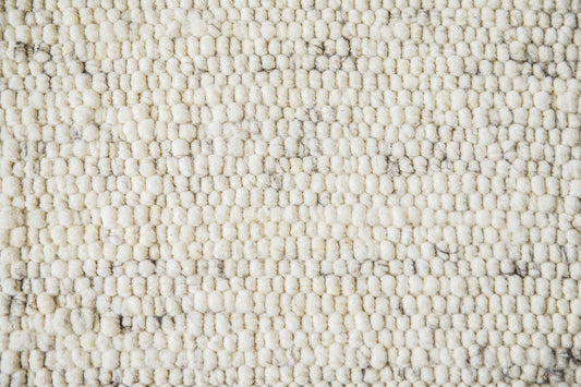 Close-up van Texelkleed Branding, gemaakt van witte Texelse schapenwol met een beetje blauw erbij.