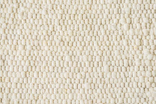 Close-up van Texelkleed Branding, gemaakt van witte Texelse schapenwol.