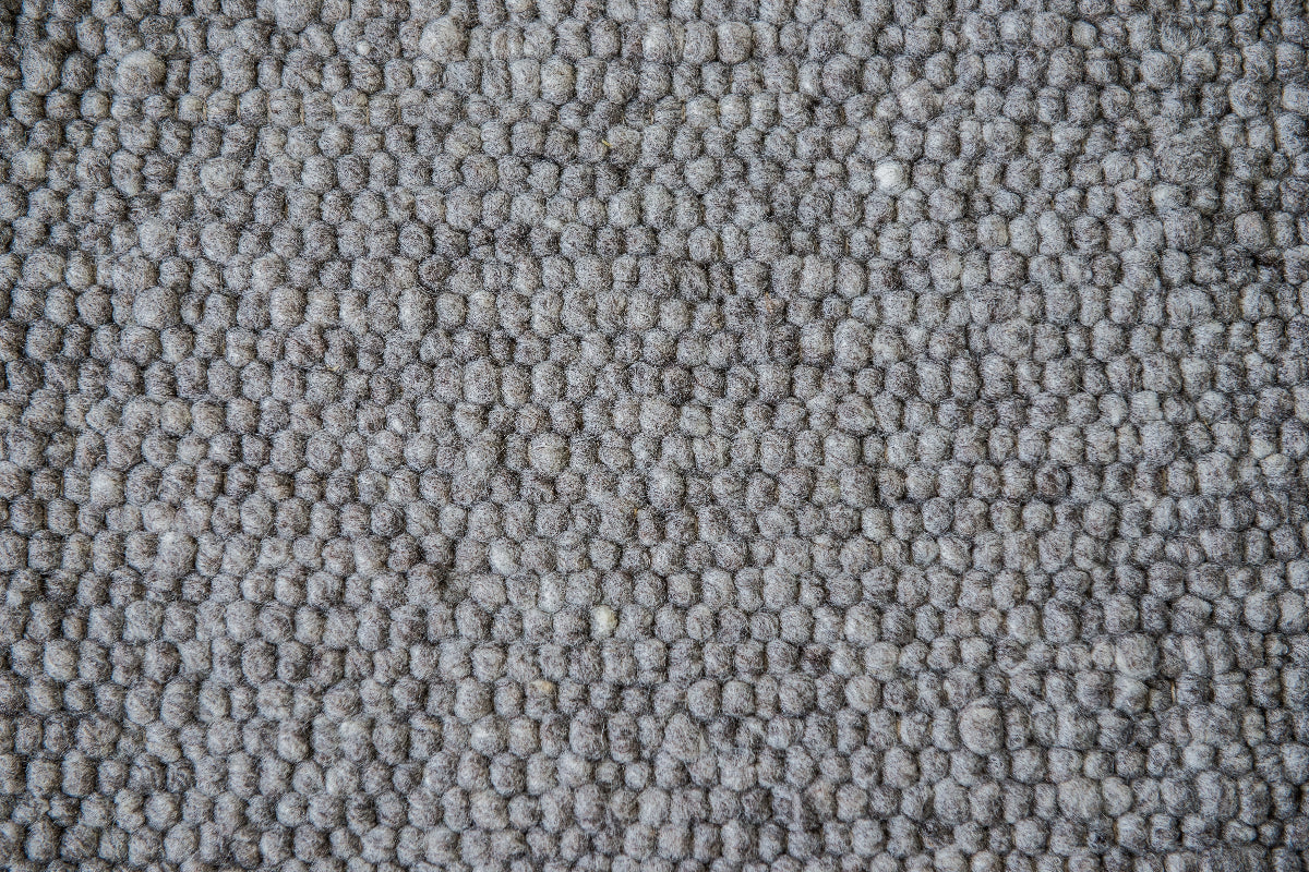 Close-up van Texelkleed Slufter, gemaakt van 50 % witte en 50% blauwe Texelse schapenwol. 